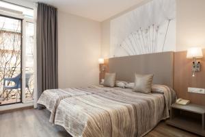 Postel nebo postele na pokoji v ubytování Hostal Centric