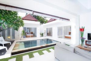 a living room with a pool in a house at Villa Leda in Seminyak