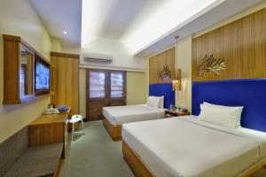 A bed or beds in a room at BE Resort Mactan
