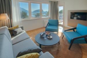 a living room with a couch and two chairs and a table at Fontana Hotel & Gastronomy in Budva