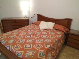 a bedroom with a bed and a lamp on a table at Apartamento nuevo en Vilafamés in Vilafames