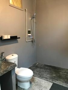 a bathroom with a white toilet in a stall at GRAYHAUS Residence in Petaling Jaya