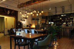 a restaurant with a table and chairs and a bar at GONGGAN Residence Hotel in Geoje