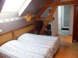 a bedroom with a bed in a room with a window at gite du chêne in Bierne