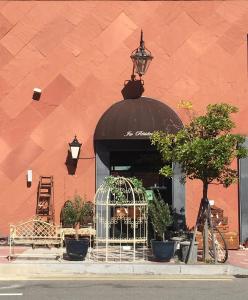 a store front with a black awning and plants in a window at GONGGAN Residence Hotel in Geoje 
