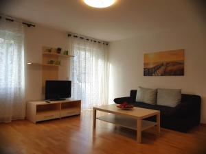 a living room with a couch and a coffee table at Freiburg Apartment in Freiburg im Breisgau