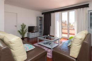 a living room with a couch and a table at Casa dos Avós by Rent2U, Lda in Funchal