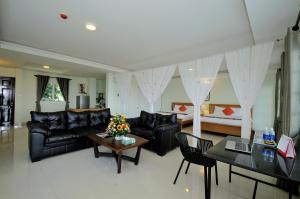 a living room with a couch and a table and a bed at Ananas Beach Hotel in Vung Tau +63 photos