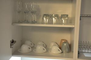 a cupboard with glasses and glass items on it at Rubio Residence - Accmonia Luxury Apartment in Arad