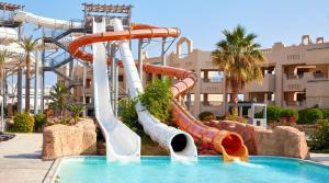 a water slide in a pool at a resort at Coral Sea Waterworld Sharm El Sheikh in Sharm El Sheikh