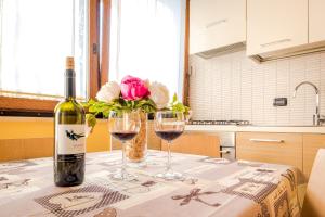 a bottle of wine sitting on a table with two glasses at B&B La Casa Di Plinio in Pompei