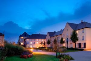 a row of buildings at night at Campanile Val de France in Magny-le-Hongre