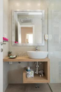 a bathroom with a sink and a mirror at Apartment Coral in Dubrovnik