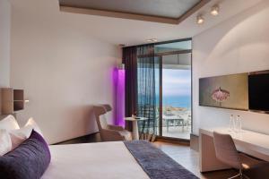 a hotel room with a bed and a television at Royal Beach Hotel Tel Aviv by Isrotel Exclusive in Tel Aviv