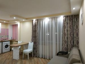 a living room with a couch and a table at Apartments in the Center Maidan in Rivne