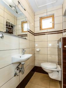 a bathroom with a sink and a toilet at Sara Apartments Malinska in Malinska