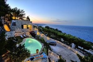- une vue aérienne sur une maison avec une piscine et l'océan dans l'établissement Ville Belvedere Luxury Accommodation, à Gagliano del Capo