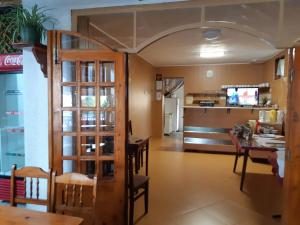 a dining room and kitchen with a table and chairs at Къща за гости "Матеви" in Obzor