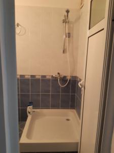 a small bathroom with a shower and a sink at Къща за гости "Матеви" in Obzor +86 photos
