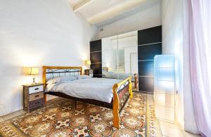 a bedroom with a bed and a large mirror at Valletta Heritage Town House in Valletta