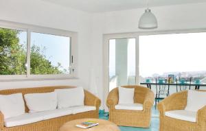 a living room with two chairs and a couch at Meravigliosa casa con vista Tropea in Santa Domenica +24 photos