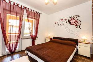 A bed or beds in a room at Sara Apartments Malinska