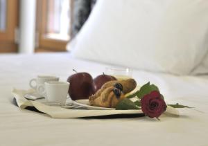 A bed or beds in a room at Al Theatro Palace