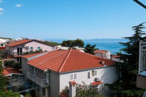 a view of a building with red tile roofs at Lendas Apartments & Rooms in Baška Voda