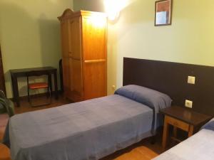 Ένα ή περισσότερα κρεβάτια σε δωμάτιο στο Apartamentos La Ceña
