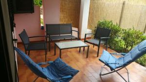 a group of chairs and a table on a patio at Villette Simius in Villasimius