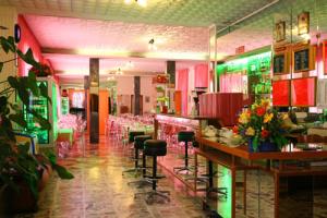 Hotel Parigi في ريميني: مطعم مع بار وكراسي في الغرفة