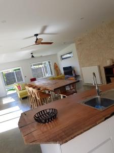 a kitchen and living room with a table and chairs at Zeally Bay Stay Deep Ocean in Torquay
