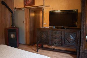 a bedroom with a television on top of a dresser at Luna del Valle in Nueva de Llanes