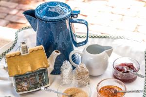 a blue teapot and other items on a table at Peppercorns B&B in McLaren Vale