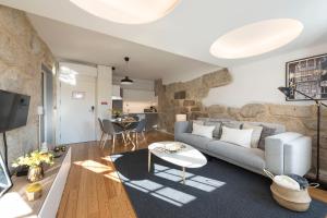 a living room with a couch and a table at LovelyStay - Sao Domingos Apartment in Porto