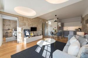 a living room with a couch and a table at LovelyStay - Sao Domingos Apartment in Porto
