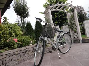 a bike with a basket parked next to a gate at Hotel Bel Sit in Comano Terme