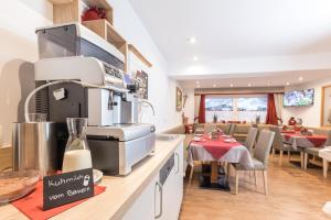 a kitchen with a stove and a dining room at Hieserhof in Neustift im Stubaital