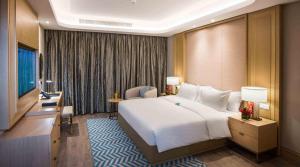a hotel room with a large bed and a television at Boudl Al Olaya in Riyadh