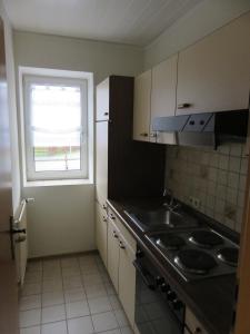a small kitchen with a sink and a window at Gollnow in Soltau