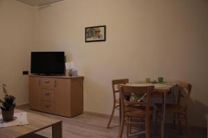 a dining room with a table and a television at Gollnow in Soltau