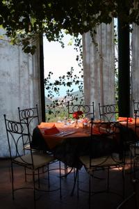 a table with chairs and a table with orange table cloth at Hotel 5 Terre Nel Sole in Deiva Marina +28 photos