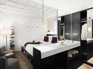 
a hotel room with two beds and a table at Yurbban Ramblas Boutique Hotel in Barcelona
