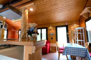a kitchen and dining room in a log cabin at Margherita Camping & Resort in Gressoney-Saint-Jean