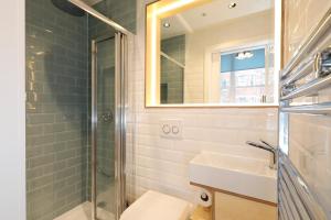a bathroom with a shower, toilet and sink at Exhibition Court Hotel in London