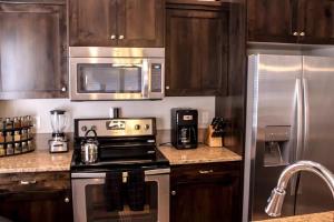 a kitchen with a stove and a stainless steel refrigerator at 11203 Arch in Boise
