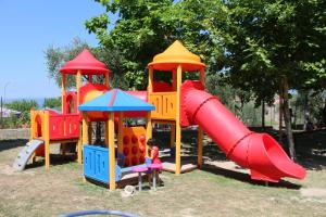 a childrens playground with a slide and a slideintend at Albatross Mobile Homes on Camping Cisano & San Vito S. p. A. in Bardolino