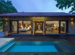 a villa with a pool and a bedroom at Anantara Kalutara Resort in Kalutara