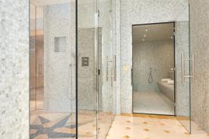 a bathroom with a shower and a toilet at Hôtel Regina Louvre in Paris