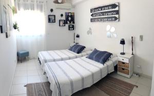 two beds in a room with white walls at Kazalena in Saint-Pierre